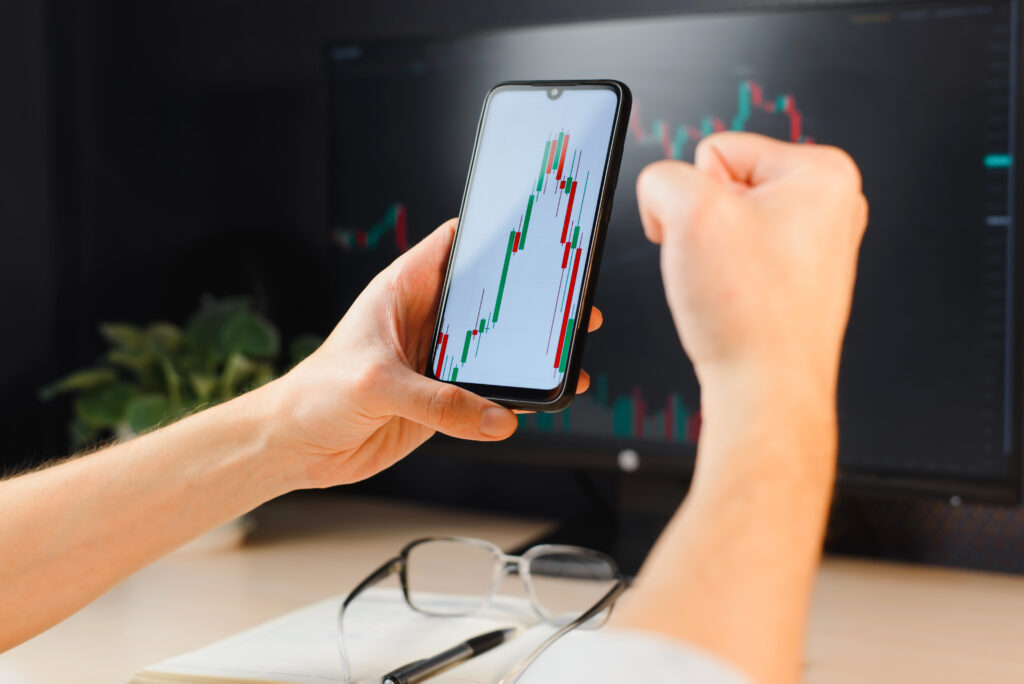 Investing and trading, business, finance and technology. Close-up of trader broker's hand holding